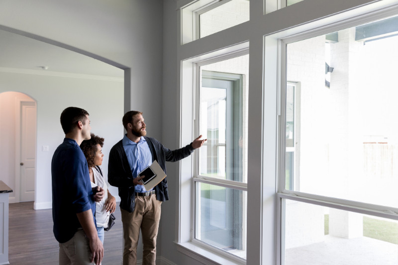 A real estate agent showing a couple around